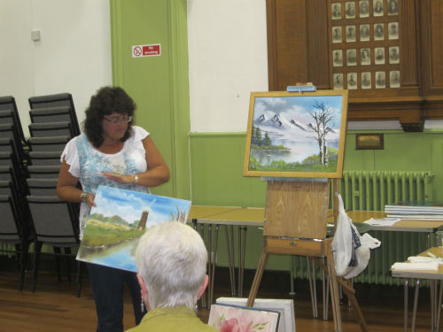 Jayne Good with her painting created using the 'Bob Ross' wet on wet oil technique
